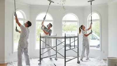 Technician removing popcorn ceiling in Denver, CO home for smooth paint-ready surface